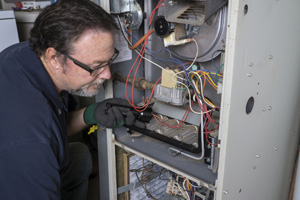 Worker checking furnace